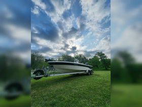 A sleek speedboat on a trailer, set against a dramatic sky, showcasing the perfect vessel for water adventures.