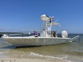 Two children enjoy a day at the beach aboard a boat, capturing the essence of family fun on the water.