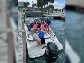 A joyful group of family and friends gathers on a boat, capturing a fun moment together — perfect for family outings and celebrations on the water.