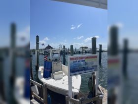 A speedboat docked at a marina, ready for private charter excursions. Ideal for exploring the beautiful waters of Islamorada.
