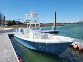 A sleek speedboat docked at the marina, showcasing its stylish design and ready for adventure on the water.