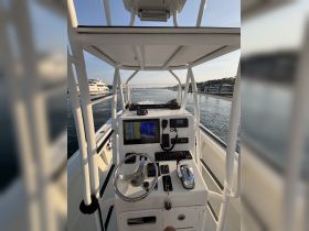 A detailed view of the helm and console area of a boat, showcasing navigational equipment and controls, ideal for boating enthusiasts and those interested in marine technology.