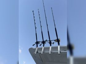A close-up view of fishing rods and reels mounted on a boat, showcasing essential gear for an exciting day of fishing on the water.