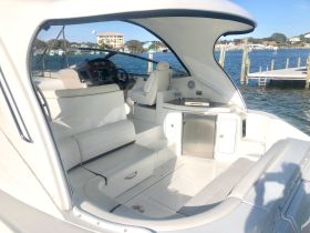 A sleek interior view of a boat's helm and seating area, showcasing modern design and comfort for an enjoyable boating experience.