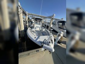 A pristine center console boat docked at the marina, showcasing its sleek design and ready for a day on the water.
