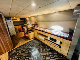 A well-designed boat kitchen interior featuring modern cabinetry and ample workspace, perfect for preparing meals while on the water.
