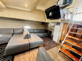Interior view of a spacious boat cabin featuring comfortable seating and modern amenities, perfect for relaxing during your nautical adventures.