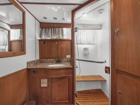 A well-appointed bathroom inside a boat, featuring modern amenities and a clean design, perfect for comfortable cruising.