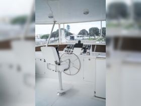 A clean and modern helm area of a boat, featuring a well-equipped console and comfortable seating, ideal for navigation and control.