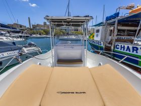 An inviting view of the helm and seating area on a boat, showcasing a comfortable space perfect for relaxing while enjoying the marina scenery.