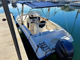 A detailed view of the interior helm of a boat, showcasing the console and seating area, perfect for a day on the water.