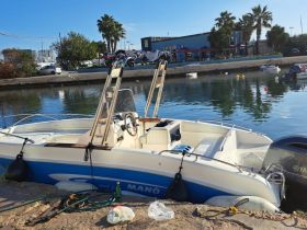 A sleek speedboat docked at the marina, showcasing its design and readiness for a day on the water.