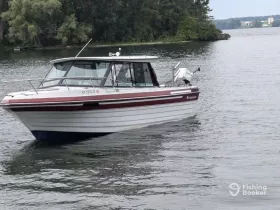 A sleek speedboat glides through calm waters, showcasing its elegant design and perfect for a day of adventure on the lake.