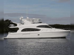 A sleek yacht is docked in calm waters, showcasing its elegant design and spacious layout, perfect for luxury cruising.