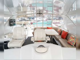 A spacious and stylish interior of a boat featuring comfortable seating and a helm area, perfect for relaxing or navigating on the water.