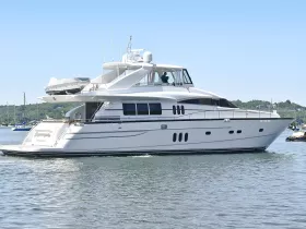 A stunning yacht cruising through calm waters, showcasing its elegant design and spacious layout — perfect for luxury outings and charters.