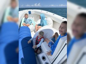 A group of children enjoys a fun day on the boat, showcasing the joy of family outings on the water.