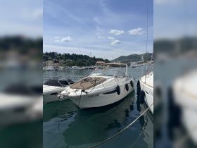 A sleek yacht docked in a picturesque marina, showcasing its elegant design and inviting atmosphere for boating enthusiasts.