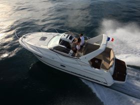 A couple enjoys a scenic ride on a sleek boat, showcasing the thrill of cruising on open waters.