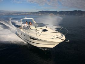 A couple enjoys a thrilling ride on a sleek boat, cutting through the water with stunning scenery in the background — perfect for adventure seekers and romantic getaways.