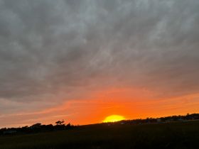 A beautiful sunset scene with vibrant orange hues, capturing the tranquil beauty of nature.