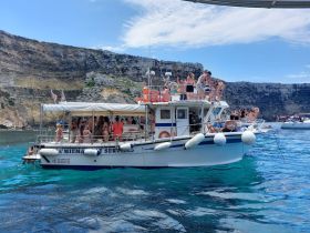 A lively group enjoys a fun day on a boat, celebrating and taking in the beautiful surroundings — perfect for summer adventures and social gatherings on the water.