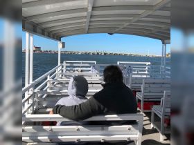 A couple enjoys a scenic view from the deck of a boat, creating a perfect moment for relaxation and connection on the water.