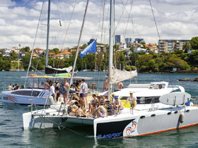 A lively group enjoys a day on a catamaran, celebrating with friends and soaking up the sun — the perfect backdrop for unforgettable memories on the water.