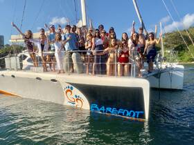A lively group celebrates aboard a catamaran, showcasing the perfect atmosphere for parties and gatherings on the water.