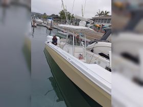 A sleek speedboat docked at the marina, showcasing its stylish design and features, perfect for a day on the water.