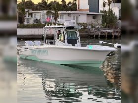 A sleek speedboat named 'Hatikvah' is docked, showcasing its modern design and features. Perfect for water adventures and day trips.