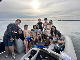 A joyful family gathers on a boat, enjoying a fun day out on the water — perfect for creating lasting memories together.