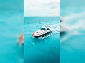 A sleek speedboat navigates through vibrant turquoise waters, showcasing the perfect vessel for thrilling adventures on the open sea.