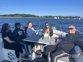 A cheerful group enjoys a day on the water, relaxing on a boat with snacks and great company — perfect for family outings or casual get-togethers.