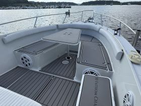 Interior view of a boat's seating area, featuring a clean and spacious layout ideal for relaxation and socializing on the water.