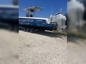 A sleek fishing charter boat, prominently displayed with its branding, ready for adventure on the water.