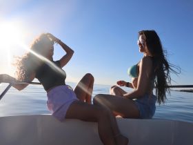 Two friends enjoy a sunny day on a boat, capturing the essence of relaxation and fun on the open water.