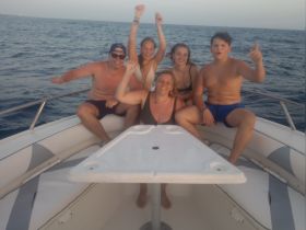 A joyful group of friends celebrates aboard a boat, enjoying their time on the water — perfect for memorable outings and adventures.