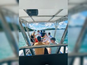 A lively group enjoys a day on the water aboard a boat, showcasing the fun and camaraderie of a boating adventure.