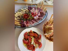 A beautifully arranged charcuterie platter featuring a variety of meats, cheeses, and fresh produce, perfect for enjoying onboard during a relaxing day at sea.