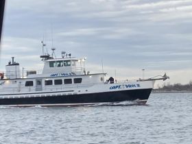 The 'Capt. Dave III' is seen navigating through the water, showcasing its sleek design and operational features.