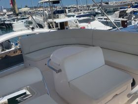 A spacious and stylish seating area inside a boat, perfect for relaxation and socializing while enjoying the marine environment.