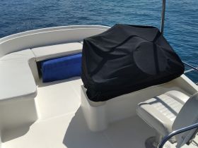 A clean and spacious interior view of a boat's helm and seating area, perfect for relaxing while enjoying the open water.