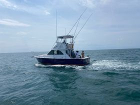 A group of anglers enjoys a day of fishing on a sportfishing boat, navigating the open ocean — perfect for adventure seekers and fishing enthusiasts.