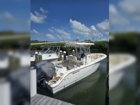 A sleek SeaFox speedboat docked at the marina, showcasing its stylish design and spacious layout, perfect for a day on the water.