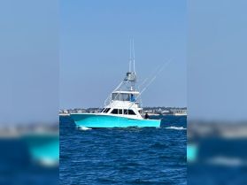 A vibrant turquoise speedboat cruising through clear waters, showcasing its sleek design and fishing gear, perfect for adventurous outings.