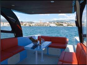 A beautifully designed interior of a boat featuring comfortable seating and a dining area, perfect for enjoying meals while cruising along scenic coastlines.