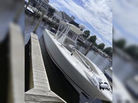 A sleek speedboat docked at the marina, showcasing its modern design and ready for a day on the water.