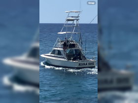 The 'Kona Dice' fishing boat is seen underway, showcasing a day of adventure on the water, perfect for fishing enthusiasts.