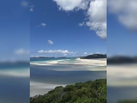 A stunning aerial view of a picturesque beach and coastline, showcasing the vibrant turquoise waters and white sands — a perfect destination for island hopping and eco tours.